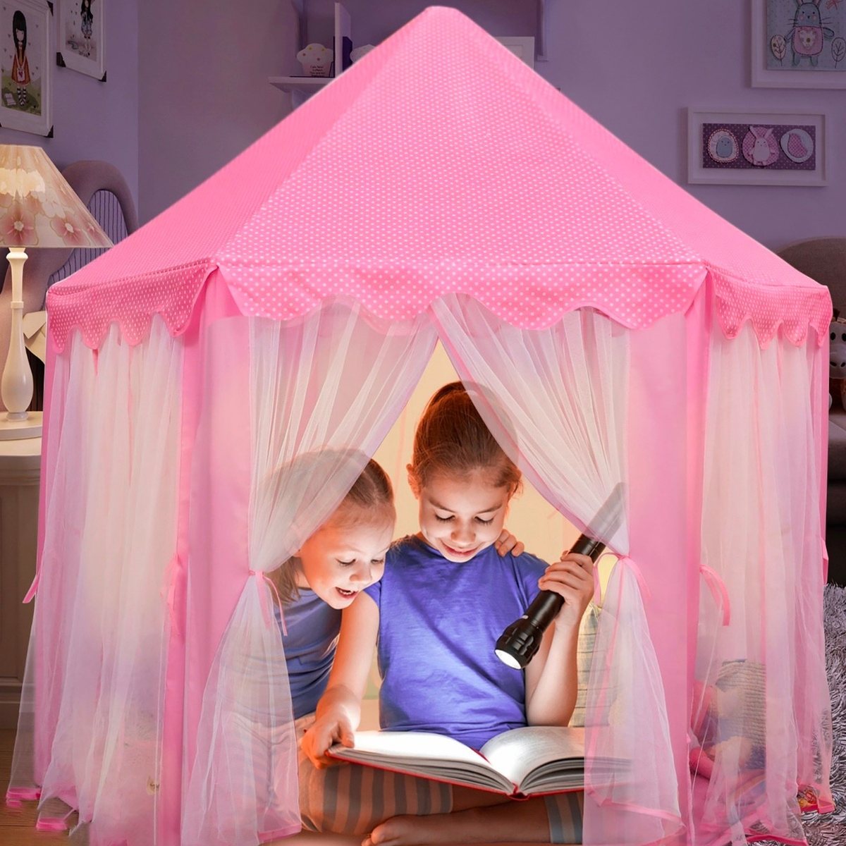 Two kids reading with a flashlight inside the Orian pink princess castle tent
